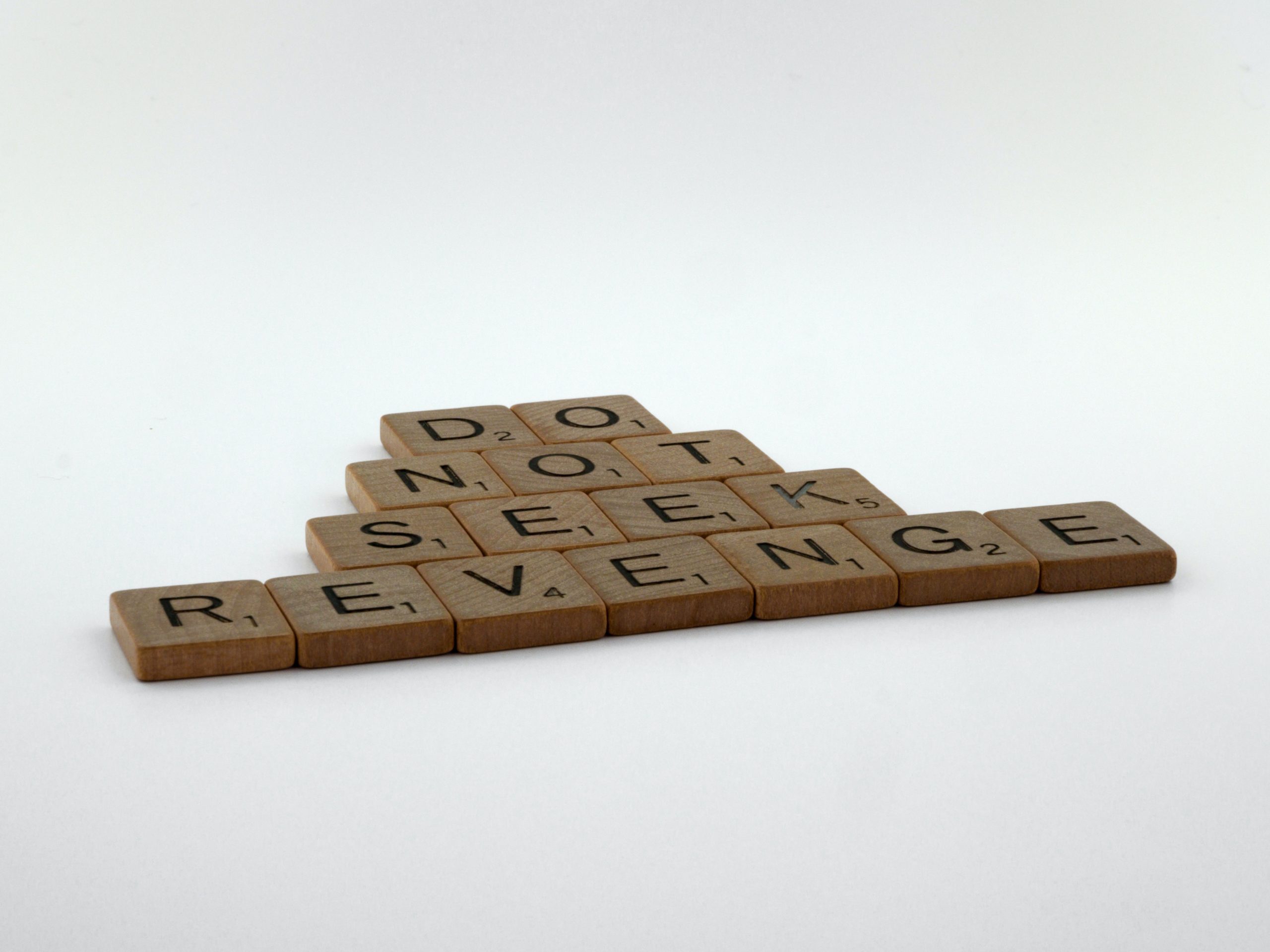Some wooden Scrabble tiles spell out, "Do not seek revenge."