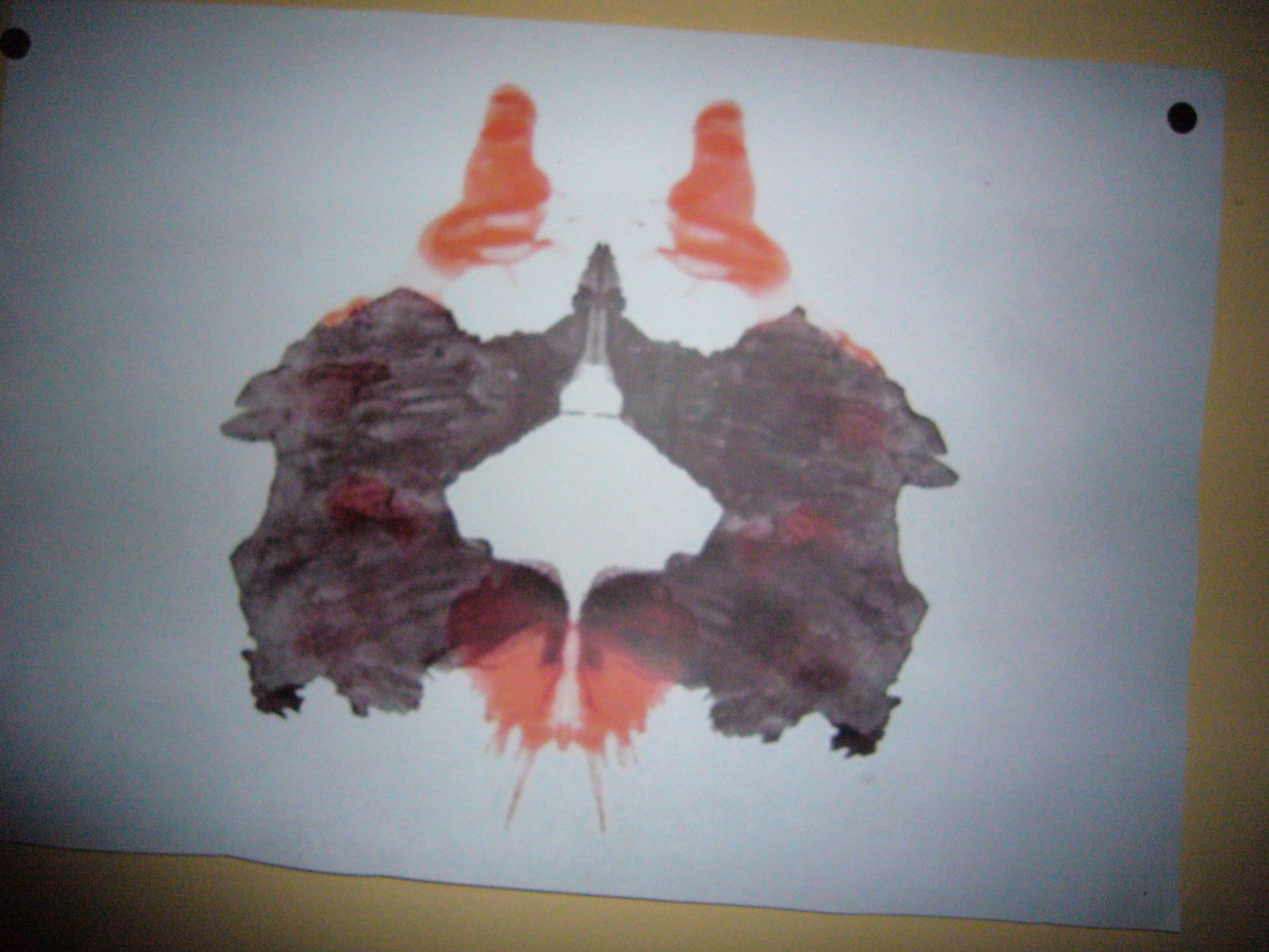 A Rorschach ink blot test that looks like two gnomes giving each other a high five.