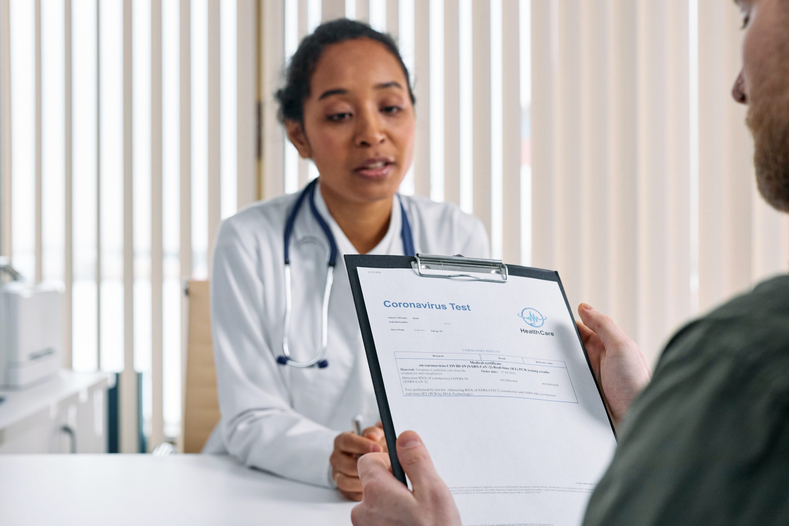 A patient is holding a Coronavirus testing form for a doctor.