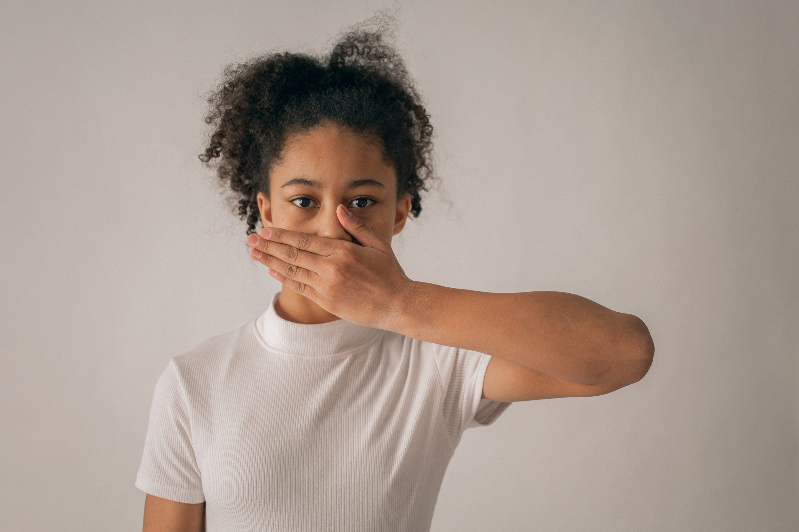 A woman is covering her mouth.