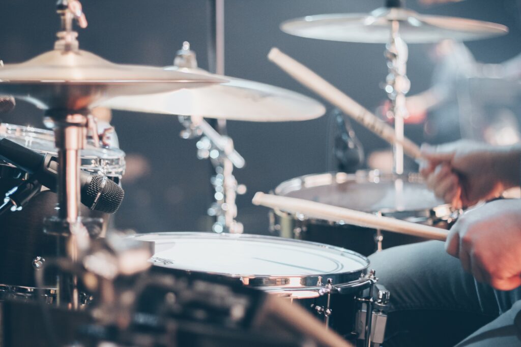Close-up of a person's hands playing a drumkit