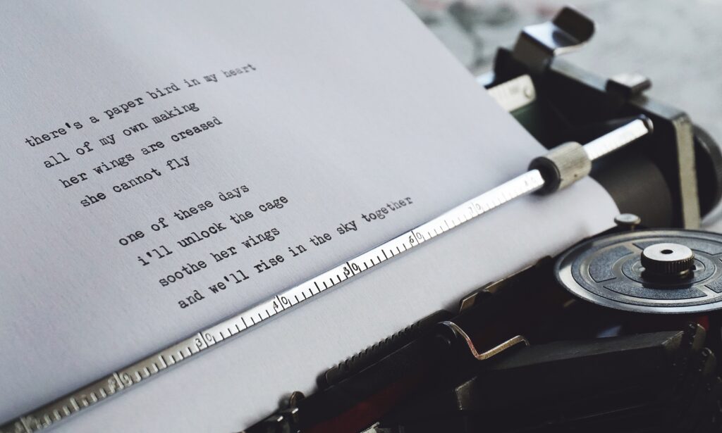 A piece of paper with some typed text on it sits inside a typewriter.