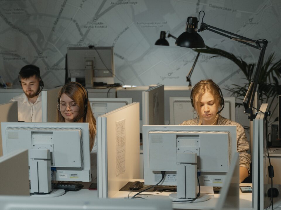 Three people work on their computers.