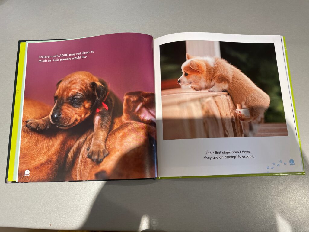 Two pages of All Dogs Have ADHD are open. The first page has a puppy lying on top of an adult dog. The text reads: "Children with ADHD may not sleep as much as their parents would like." The second page shows a puppy trying to escape over a wooden porch. The text reads: "Their first steps aren't steps... they are an attempt to escape." 