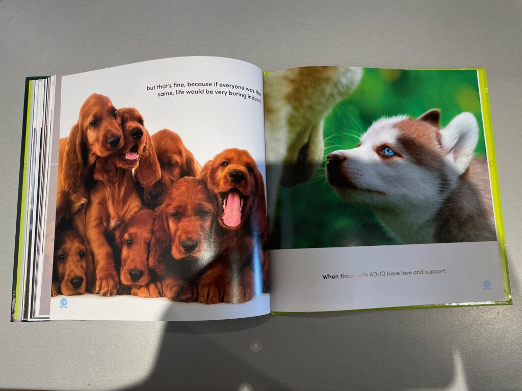 Two pages of All Dogs Have ADHD are open. The first page shows a group of brown dogs. The text reads: "but that's fine, because if everyone was the same, life would be very boring indeed." The second page shows two dogs facing each other against a green background. The text reads: "When those with ADHD have love and support." "