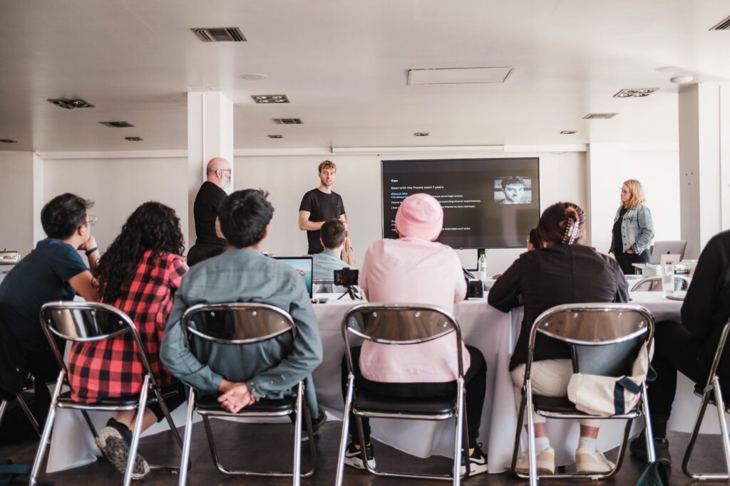 Group of people attending a workshop on neuroinclusive workplace culture in a training room.